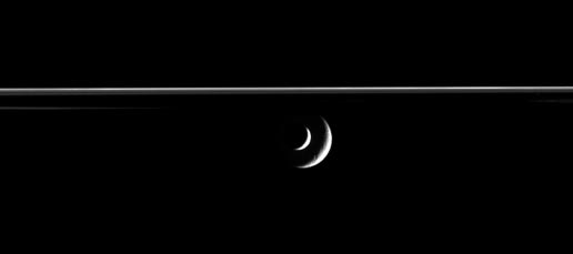 Enceladus slides past Rhea